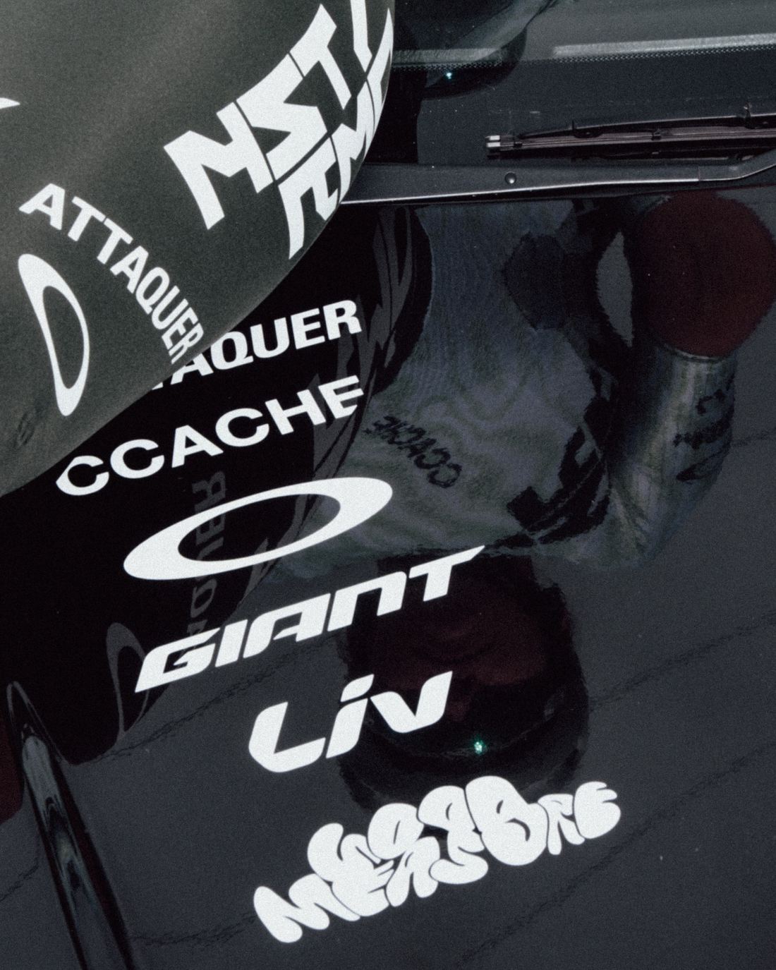 Sponsor decals across the team car bonnet and windscreen