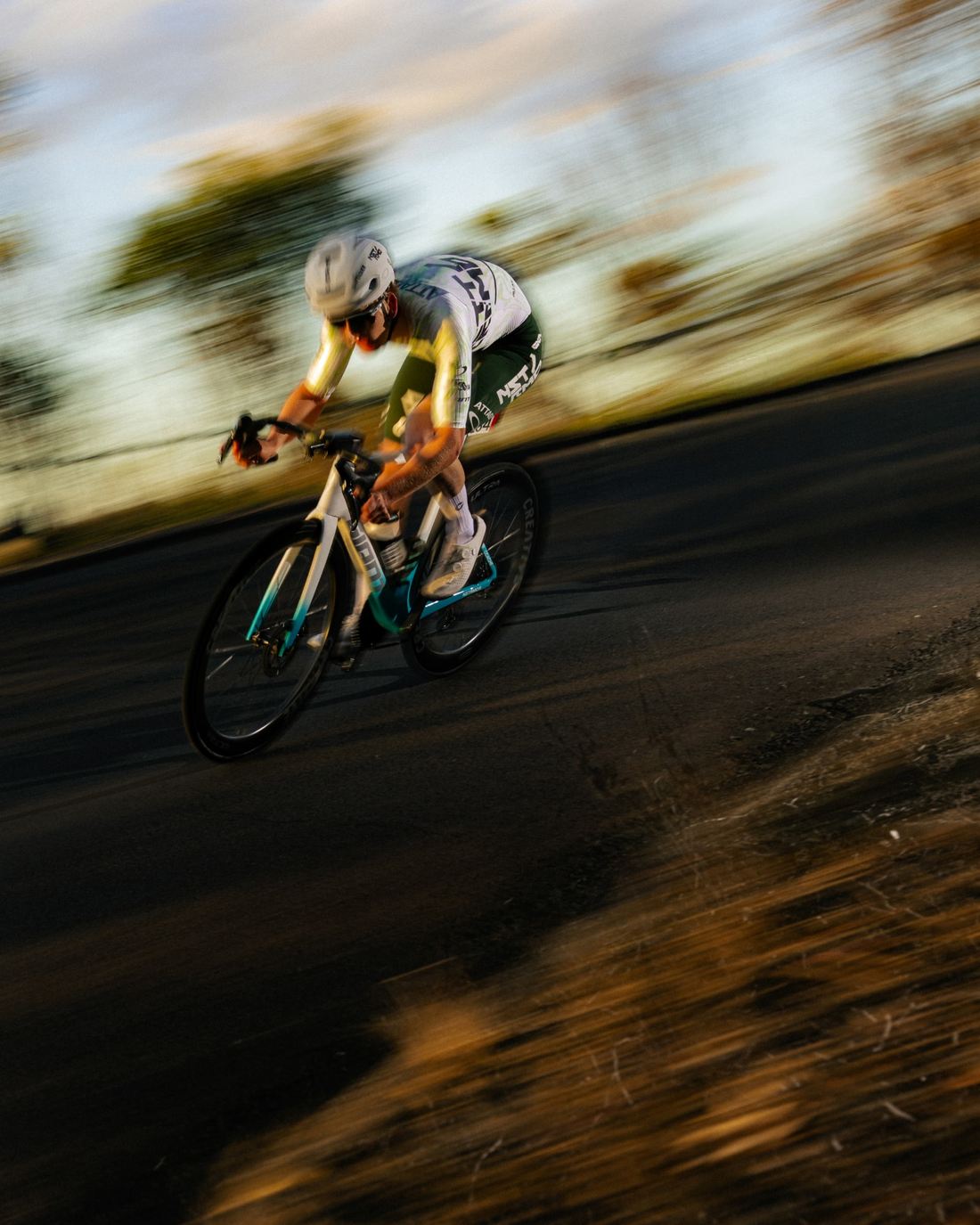NSTRMO rider cornering in evening light
