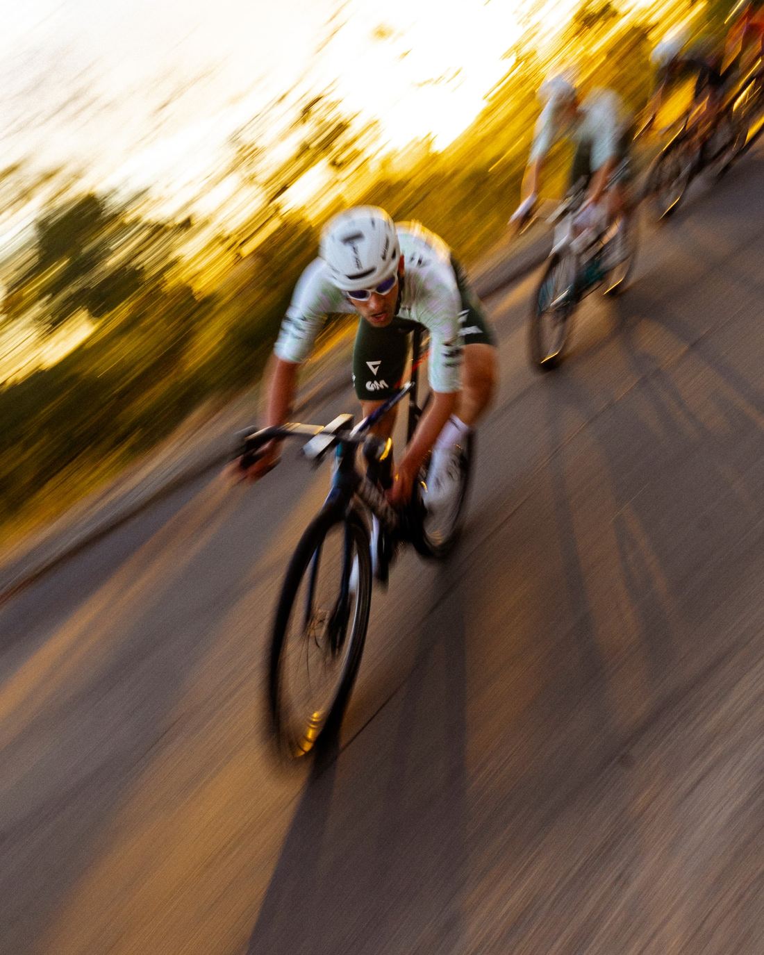 NSTRMO rider leading into a corner at sunset