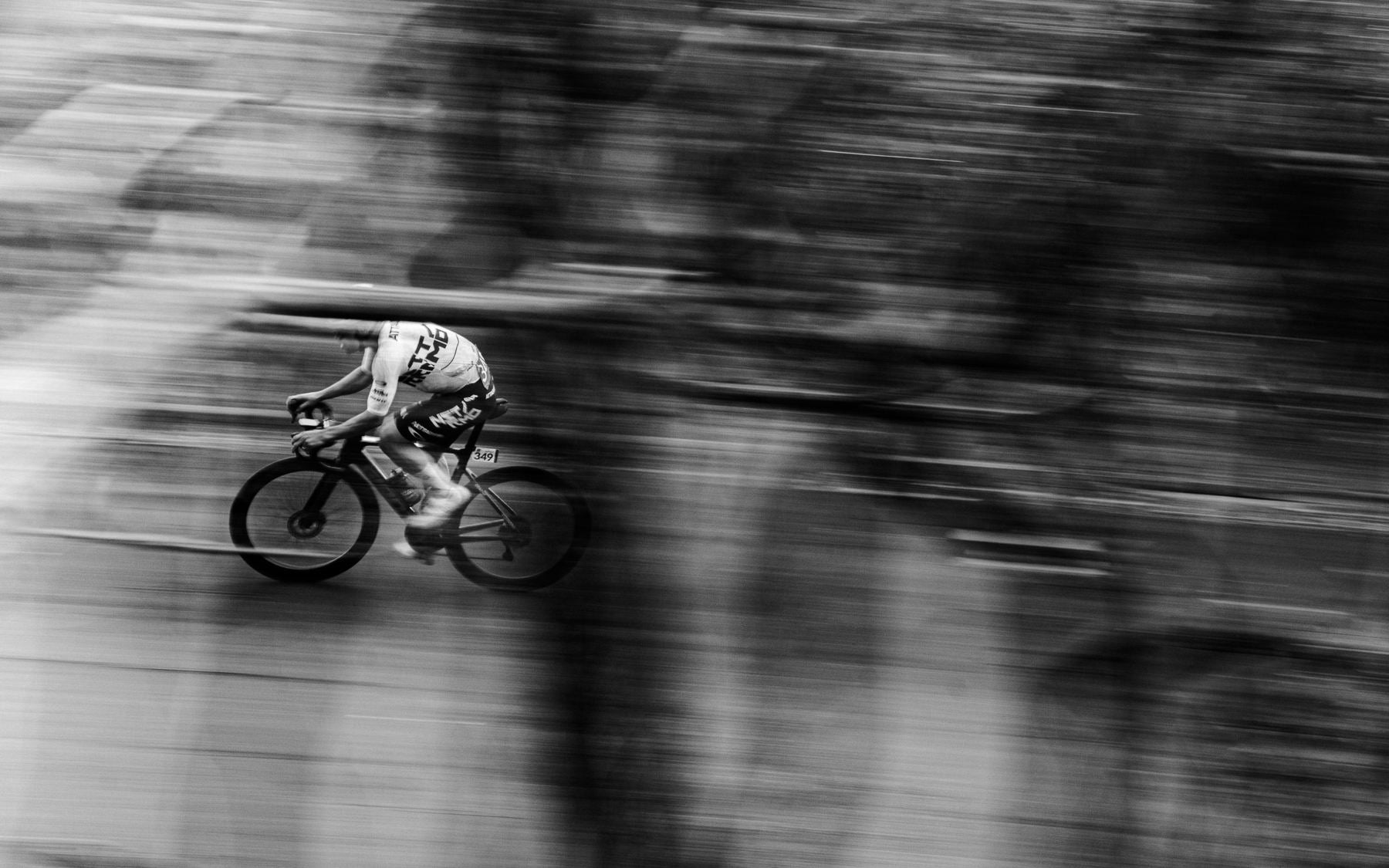 Lone NSTRMO rider at speed, black and white